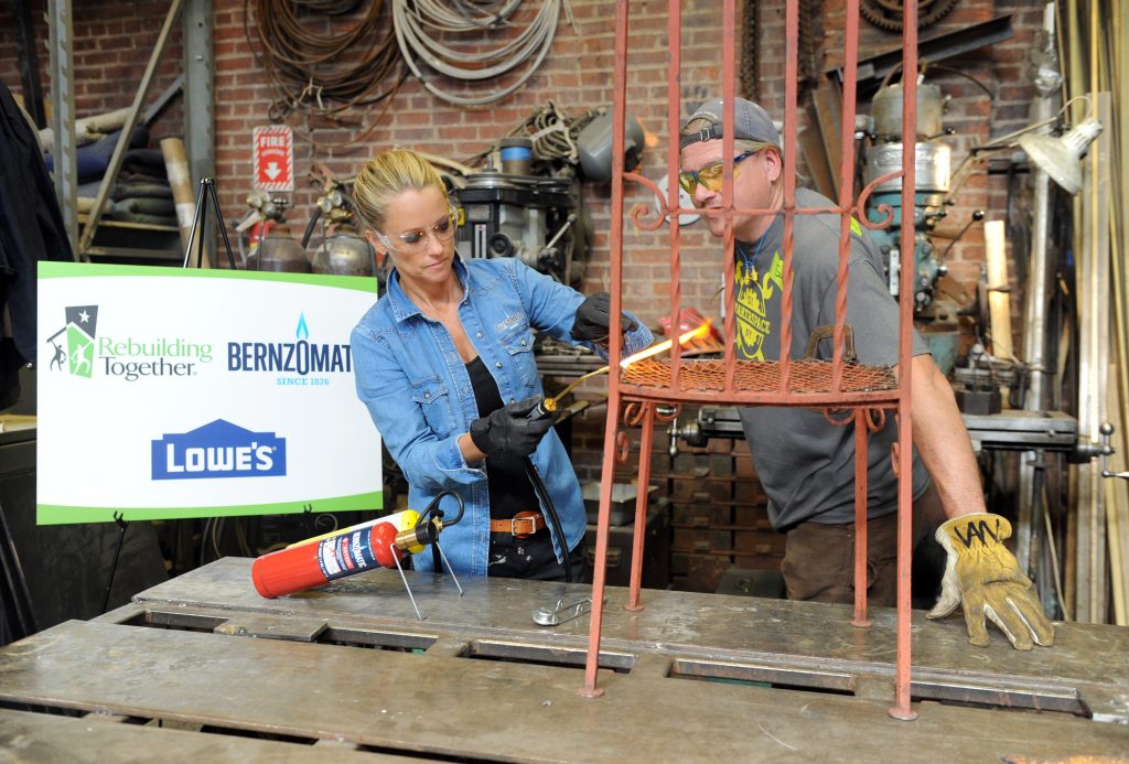 Restoration expert Nicole Curtis and Scott Van Campen, of Staten Island MakerSpace, use Bernzomatic blowtorches to repair salvaged chairs at the launch event for the Bernzomatic Find Your Fire Community Grants program, Thursday, Oct. 22, 2015, in New York. MakerSpace is a community center still feeling the effects of Hurricane Sandy three years later. Bernzomatic, the industry leader in handheld torches, is encouraging people to submit a community project for a chance to win one of three $10,000 grants and a visit from Curtis. Go to Bernzomatic.com/Grants for more information. (Photo by Diane Bondareff/Invision for Bernzomatic/AP Images)